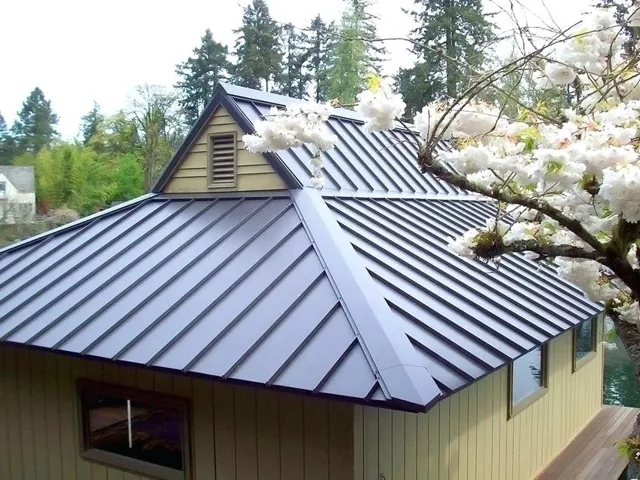 Metal roof panels on a home surrounded by trees